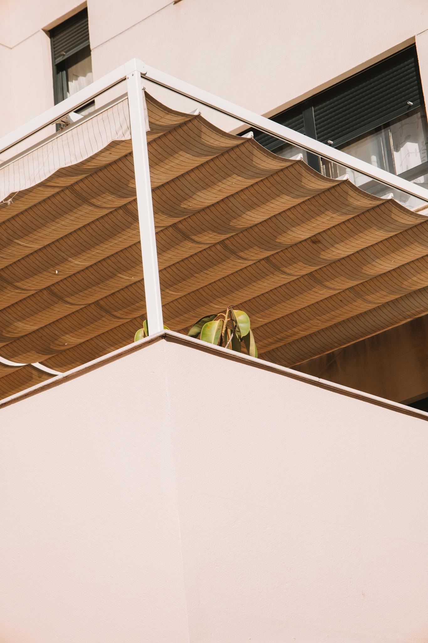 Close-up of a modern balcony with an awning in Valencia, showcasing urban architecture.